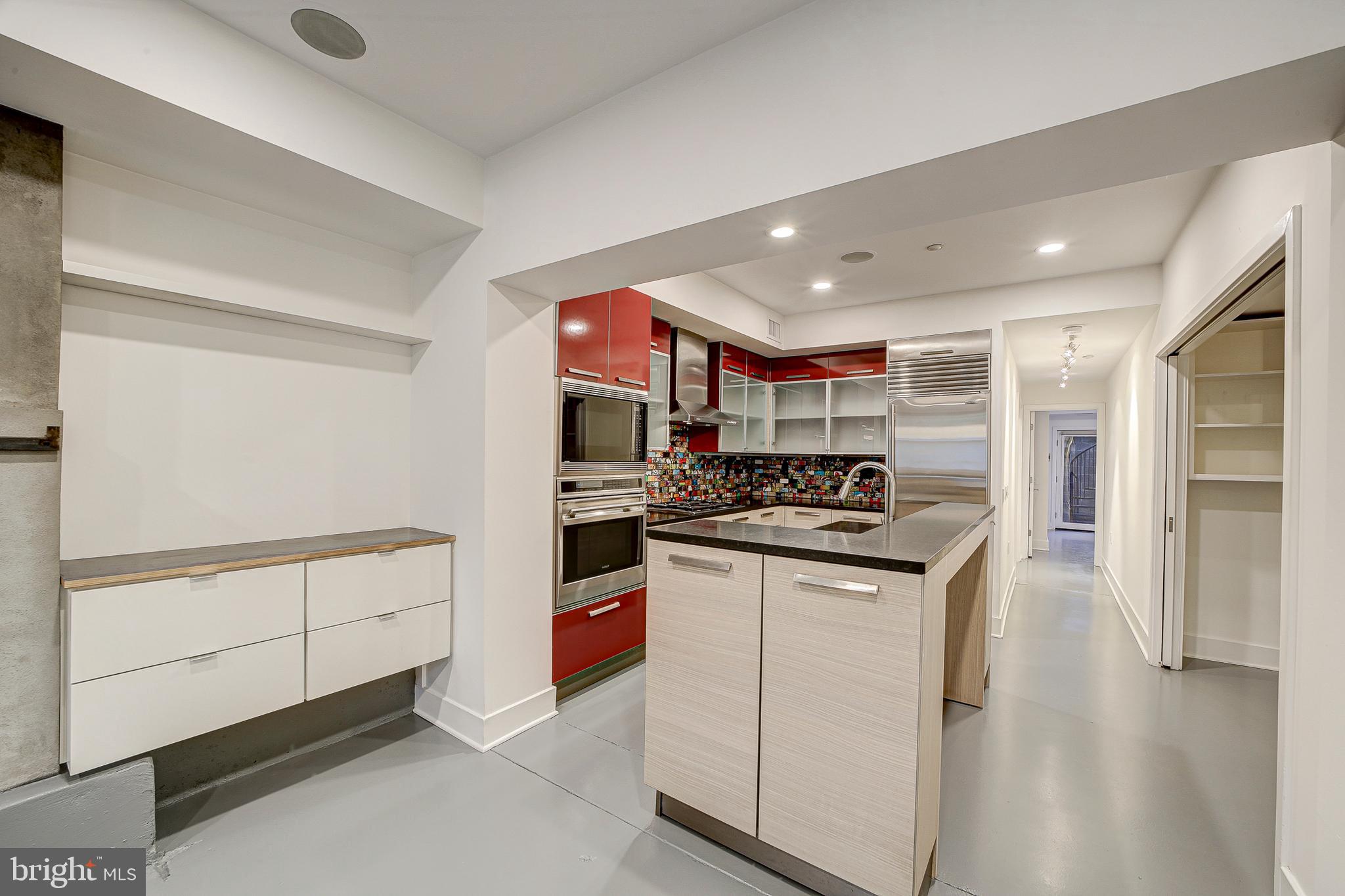 1517 Church Street Northwest, Unit A Washington, DC 20005 - Photo 5 of 23 a kitchen with stainless steel appliances granite countertop a stove and a refrigerator