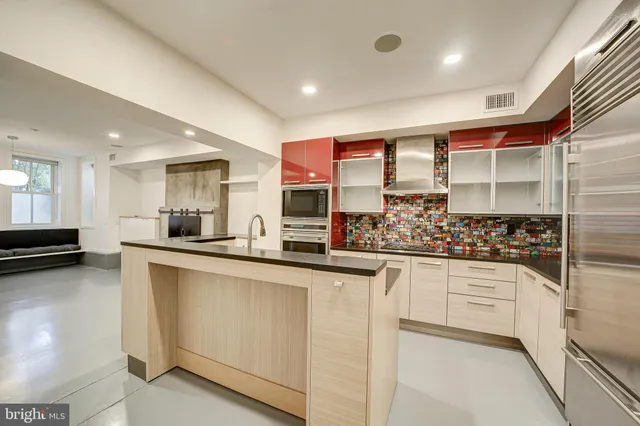 a kitchen with stainless steel appliances granite countertop a stove and a sink