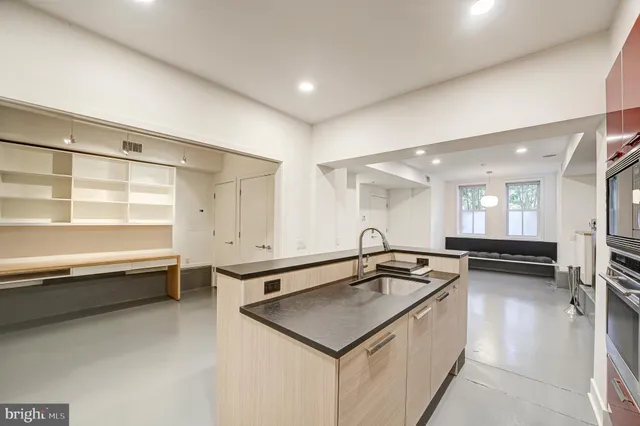 a kitchen with a sink a stove and a refrigerator