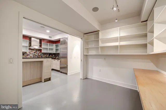 a kitchen with white cabinets and appliances