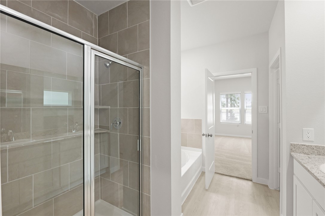 4414 Albritton Avenue Bryan, TX 77801 - Photo 25 of 30 a bathroom with a glass shower door