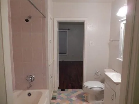 a bathroom with a toilet and a tub