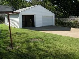 a view of backyard of house with green space