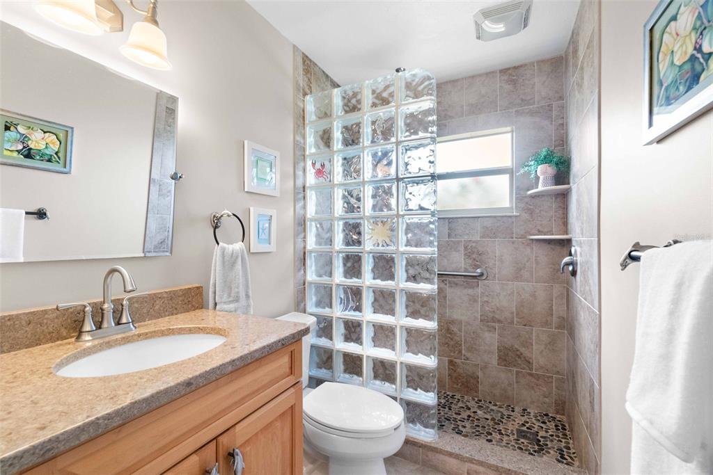 3533 Tree Line Court, Unit 13 Sarasota, FL 34231 - Photo 21 of 38 a bathroom with a sink toilet a mirror and shower