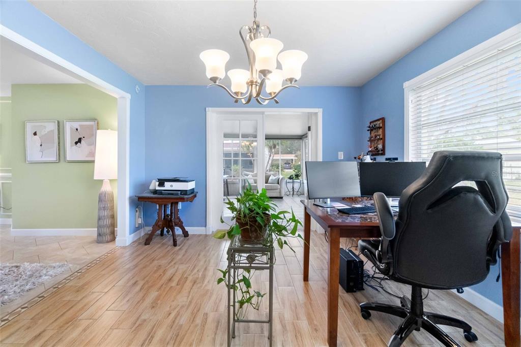 3533 Tree Line Court, Unit 13 Sarasota, FL 34231 - Photo 26 of 38 a workspace with furniture a chandelier and a window