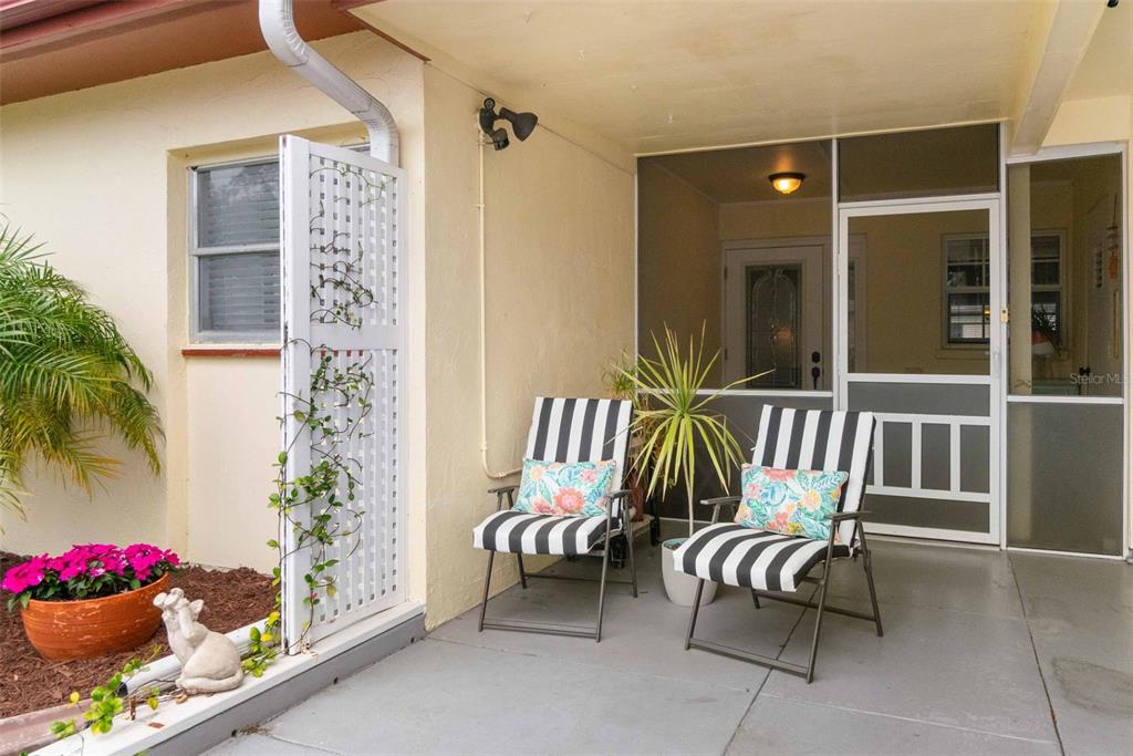 3533 Tree Line Court, Unit 13 Sarasota, FL 34231 - Photo 3 of 38 a porch with a bench and a potted plant