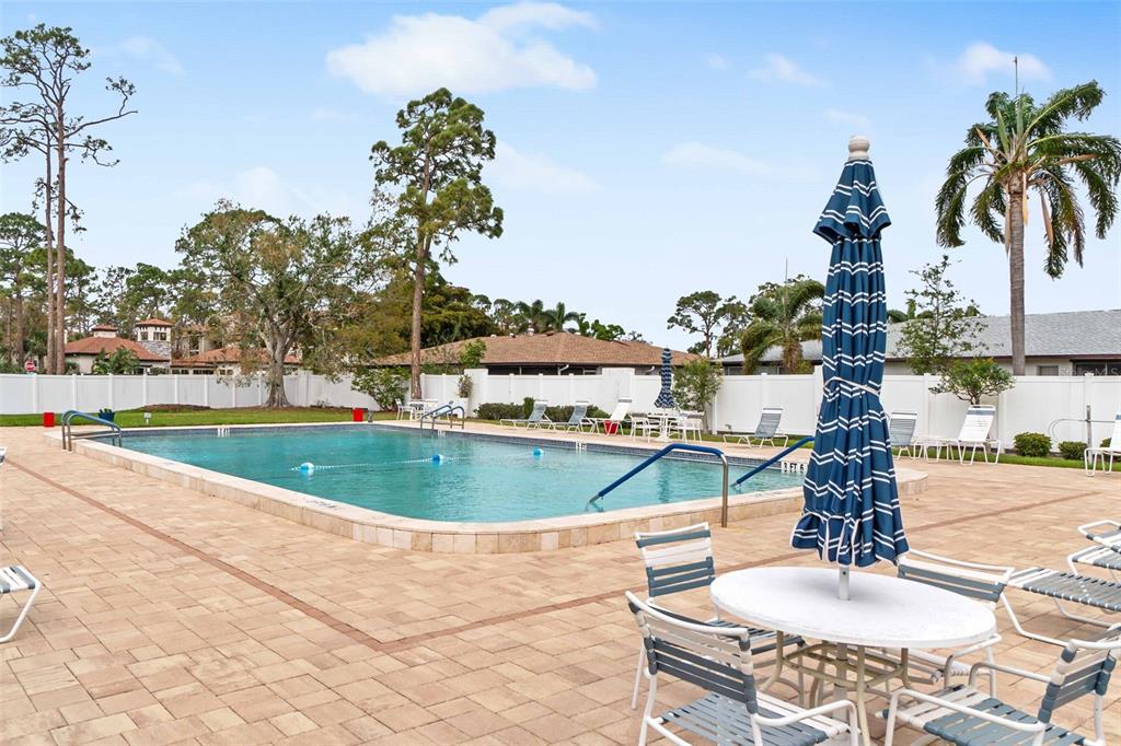 3533 Tree Line Court, Unit 13 Sarasota, FL 34231 - Photo 36 of 38 a view of a swimming pool with a fountain and a fountain