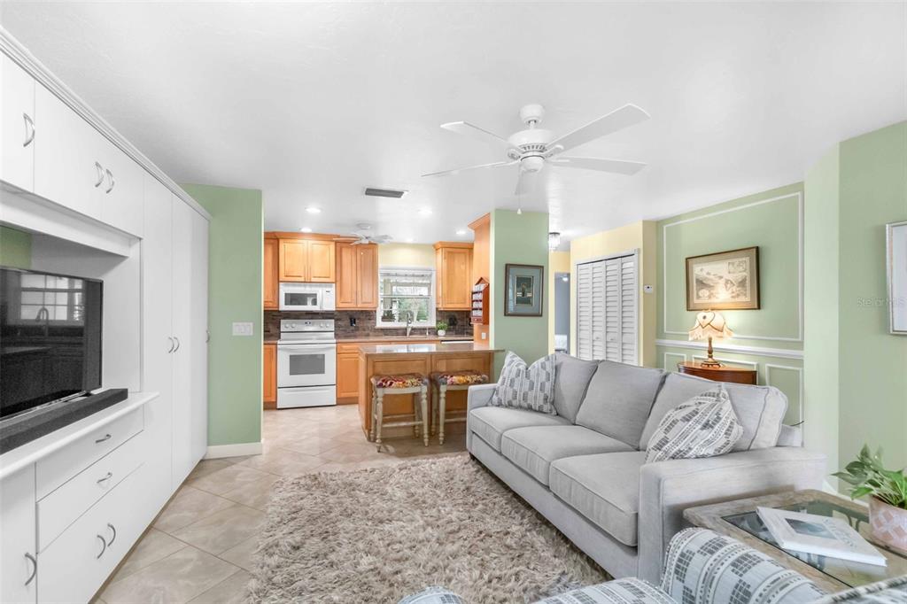 3533 Tree Line Court, Unit 13 Sarasota, FL 34231 - Photo 9 of 38 a living room with furniture and a flat screen tv
