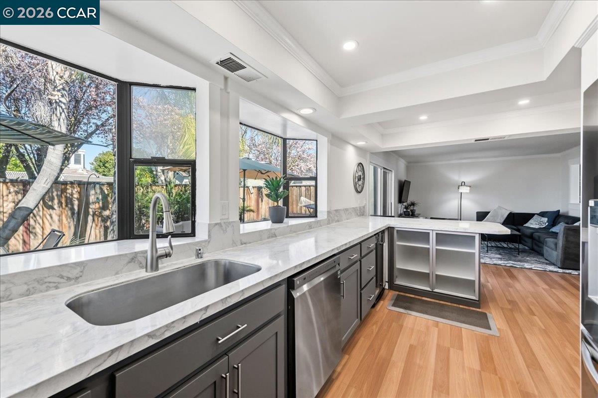 10005 Foxboro Circle San Ramon, CA 94583 - Photo 19 of 48 a kitchen with sink cabinets and wooden floor