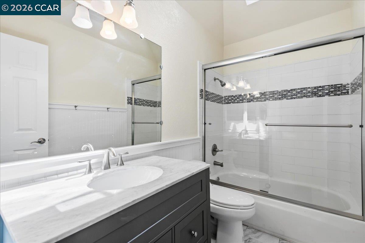 10005 Foxboro Circle San Ramon, CA 94583 - Photo 31 of 48 a bathroom with a granite countertop sink a toilet a mirror and shower