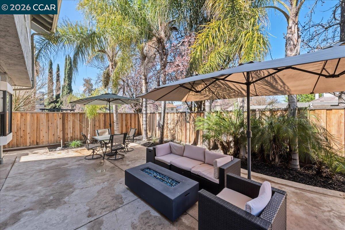 10005 Foxboro Circle San Ramon, CA 94583 - Photo 37 of 48 a view of patio with a table and chairs under an umbrella