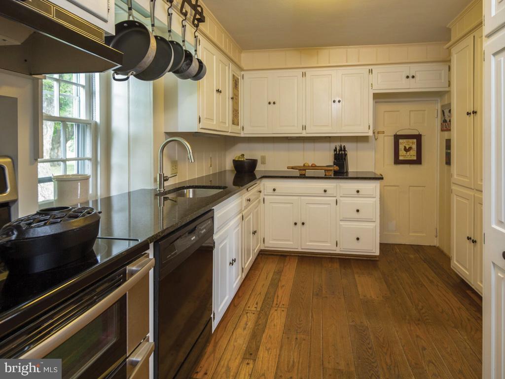 1375 Chestnut Tree Road Honey Brook, PA 19344 - Photo 3 of 15 a kitchen with granite countertop a stove a sink and cabinets