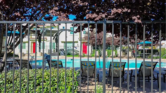 a kitchen with stainless steel appliances a sink stove refrigerator and cabinets