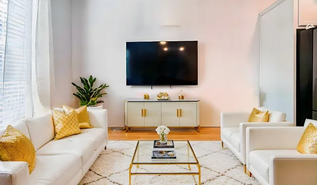 a living room with furniture and a flat screen tv