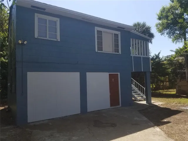 a side view of a house with a yard