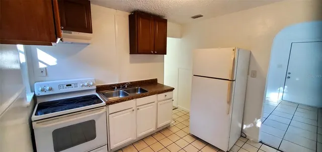 a kitchen with a stove and a refrigerator