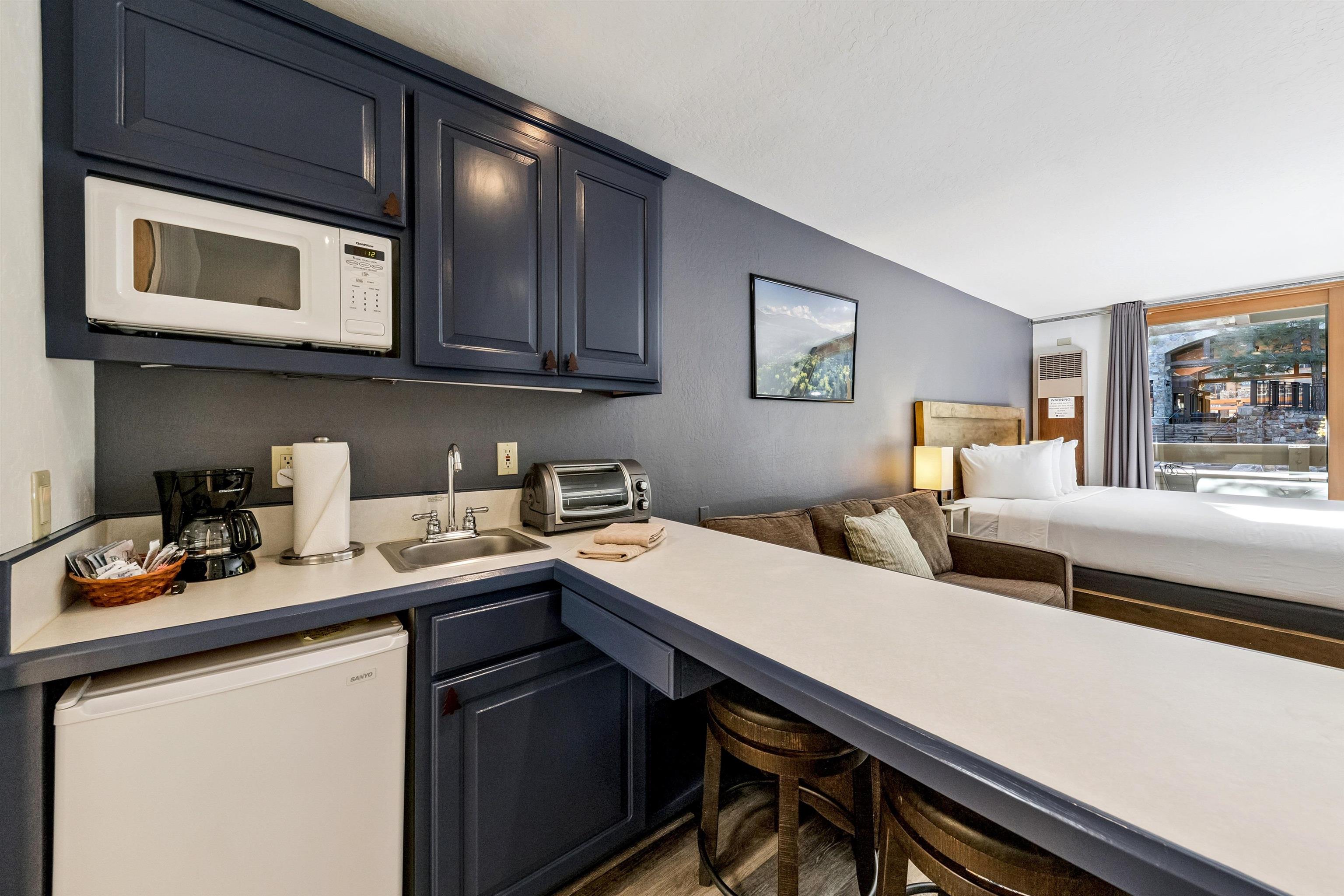 2000 North Village Drive, Unit 234 Truckee, CA 96161 - Photo 5 of 27 a kitchen with stainless steel appliances a sink a stove cabinets and a dining table