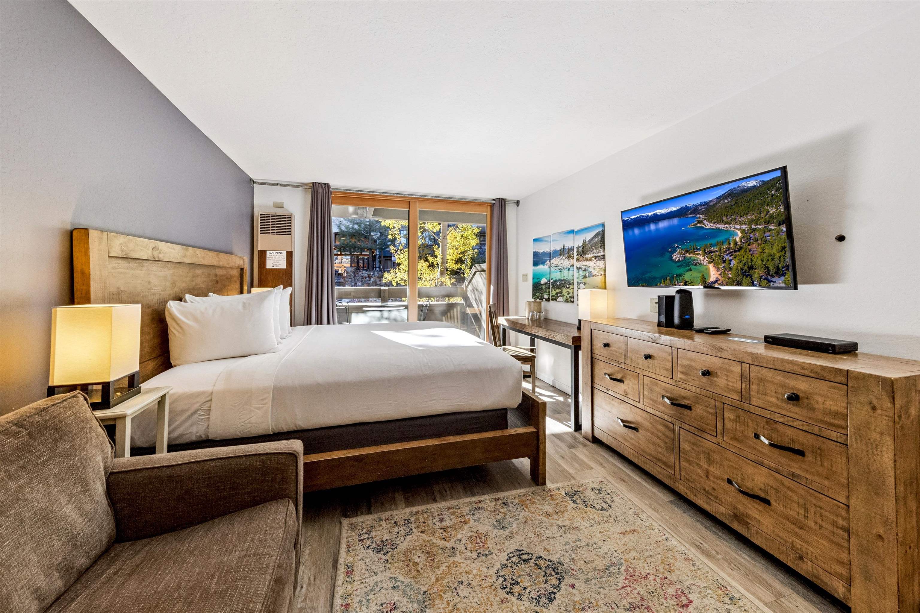 2000 North Village Drive, Unit 234 Truckee, CA 96161 - Photo 9 of 27 a bedroom with a bed and a flat screen tv