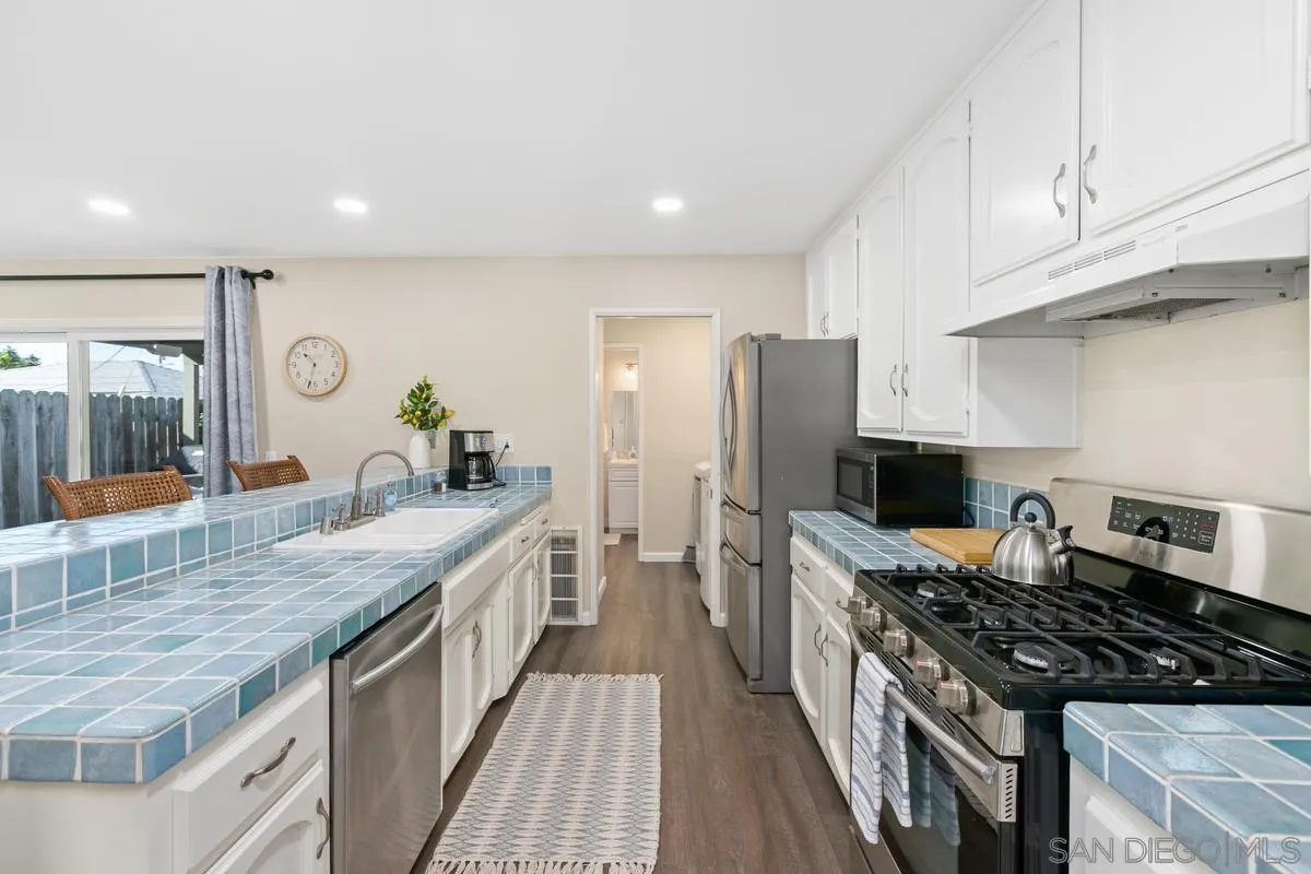 644 Silver Strand Boulevard Imperial Beach, CA 91932 - Photo 8 of 19 a kitchen with stainless steel appliances granite countertop a stove and a sink