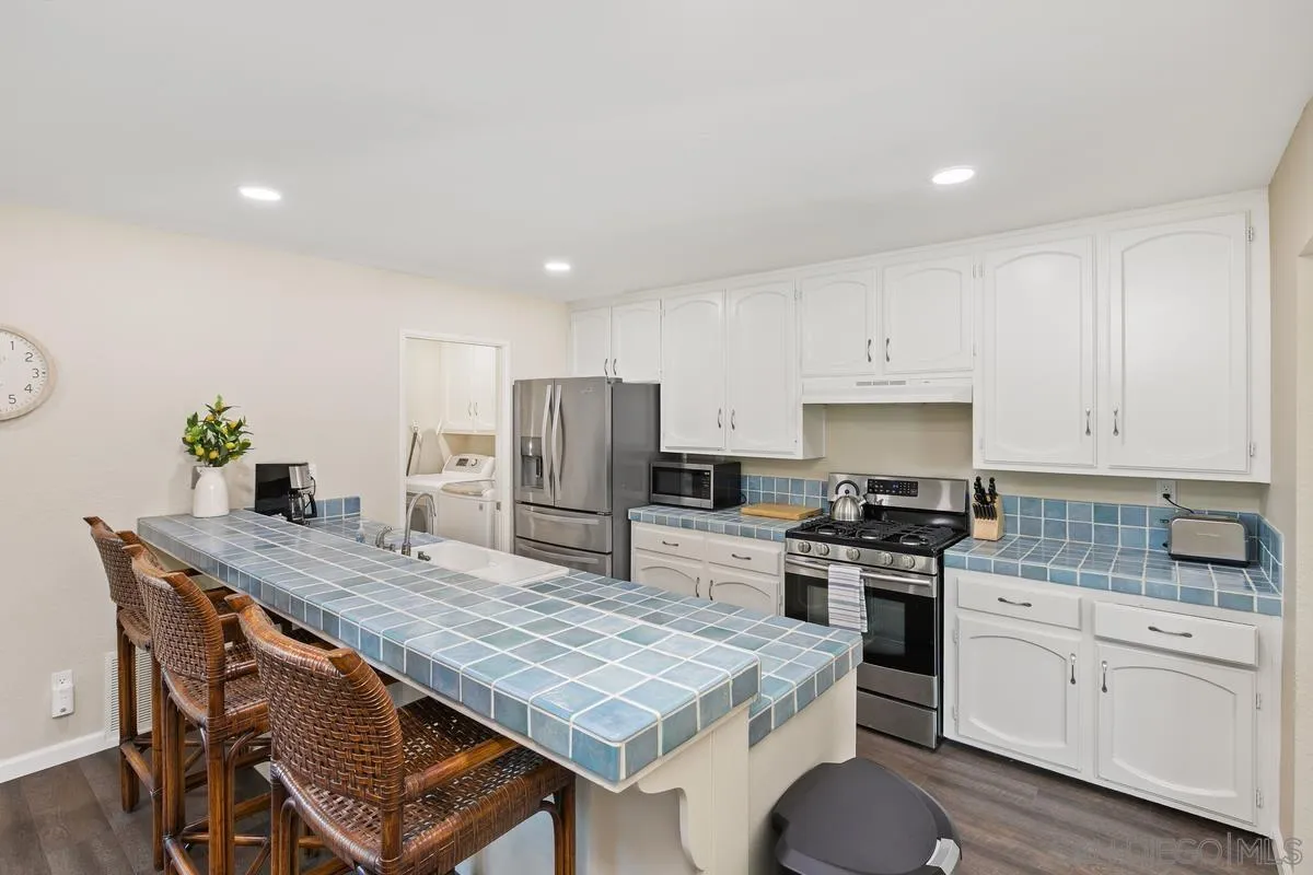 644 Silver Strand Boulevard Imperial Beach, CA 91932 - Photo 9 of 19 a kitchen with stainless steel appliances granite countertop a stove refrigerator sink and cabinets