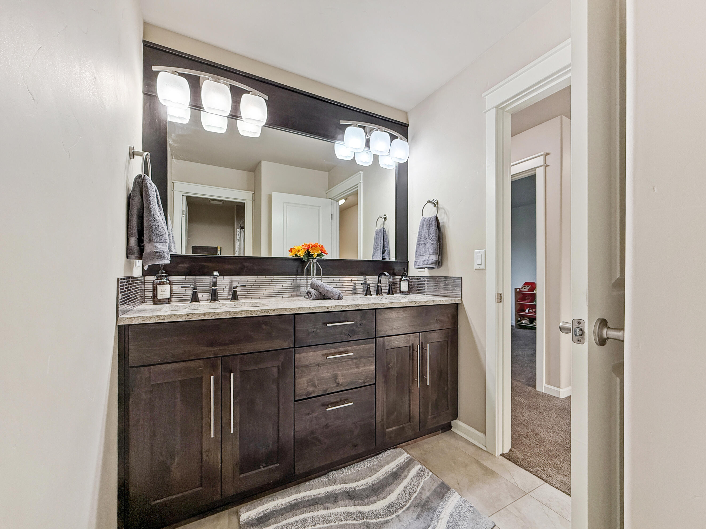 61072 Manhae Loop Bend, OR 97702 - Photo 35 of 63 a bathroom with a double vanity sink and a mirror