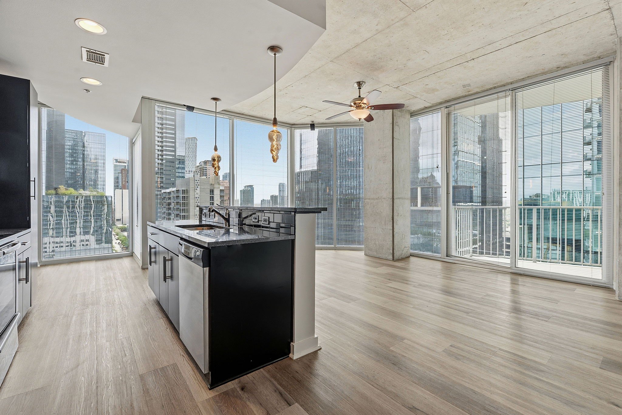 a kitchen with stainless steel appliances granite countertop a refrigerator a sink and wooden floors