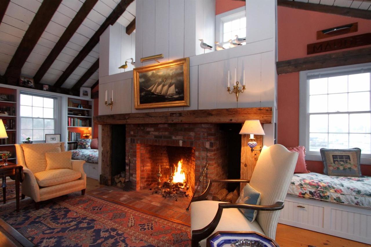38 Bridge Street Chatham, MA 02633 - Photo 15 of 28 a living room with furniture and a fireplace