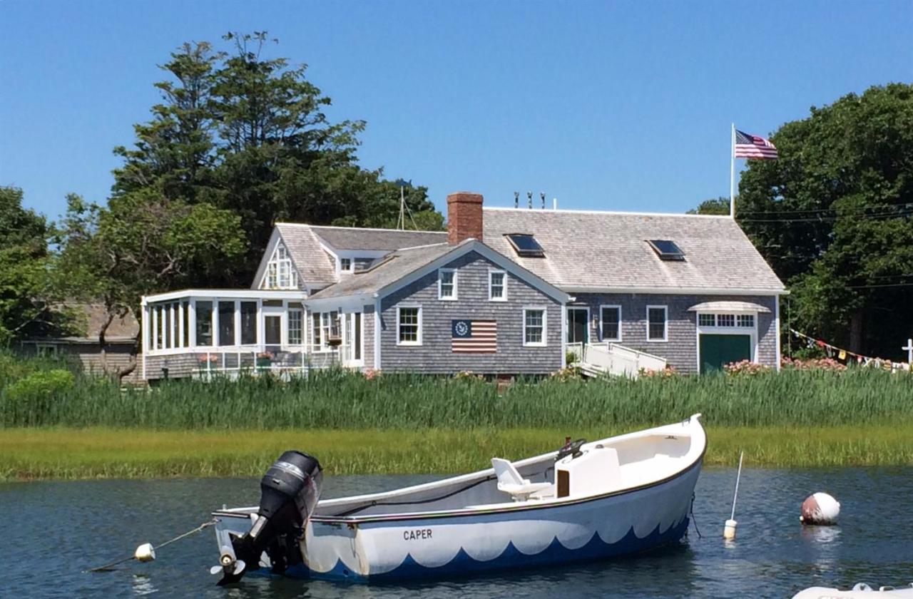 38 Bridge Street Chatham, MA 02633 - Photo 18 of 28 a front view of a house with a garden and swimming pool