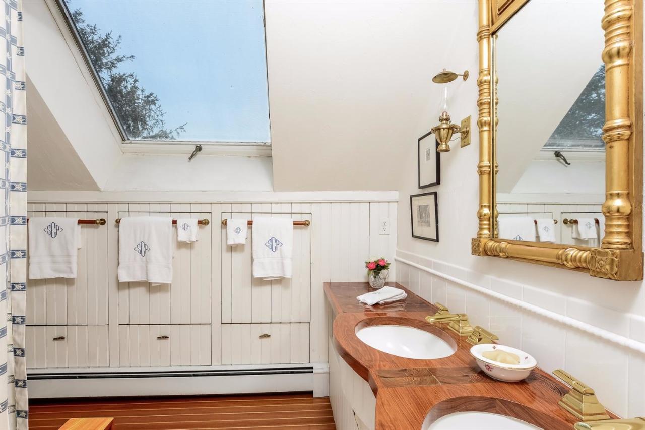 38 Bridge Street Chatham, MA 02633 - Photo 23 of 28 a bathroom with a granite countertop sink and a mirror