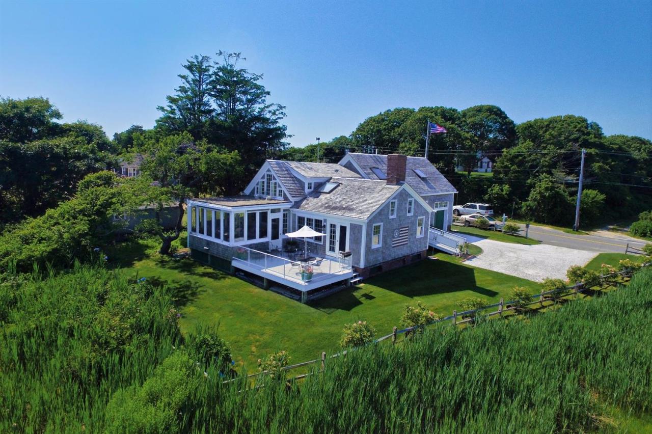 38 Bridge Street Chatham, MA 02633 - Photo 7 of 28 a aerial view of a house with a big yard plants and large trees