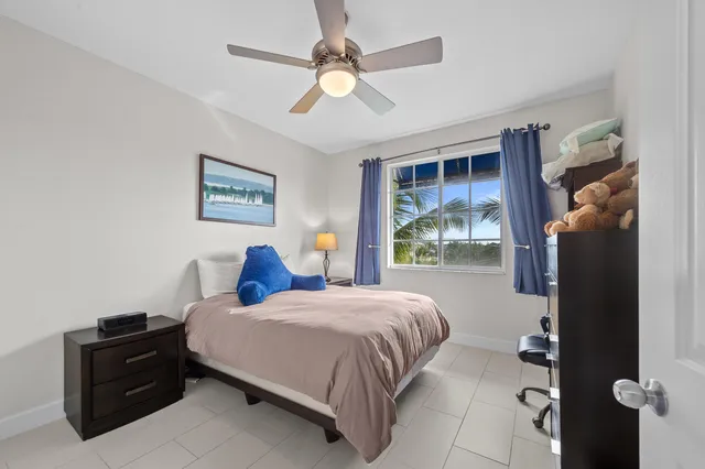 a bedroom with a bed dresser and a window