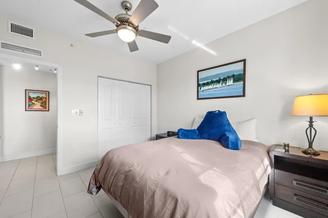 a bedroom with a bed and a lamp