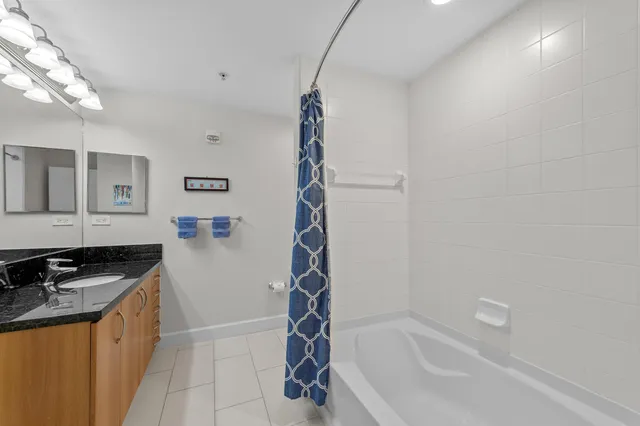 a bathroom with a bathtub a sink and a window