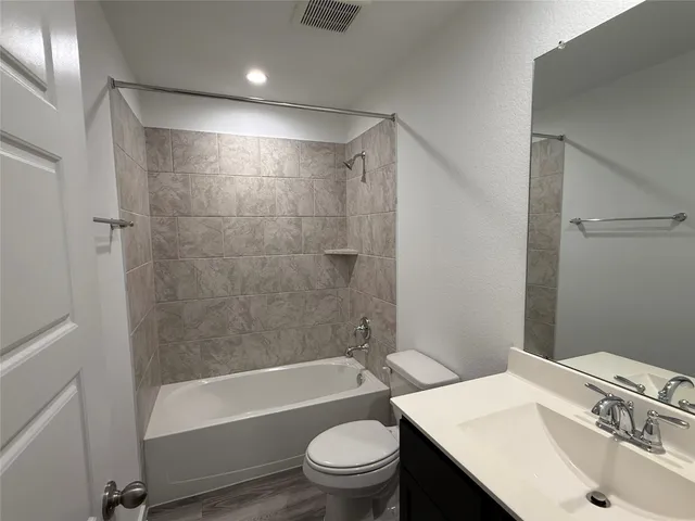 a bathroom with a sink a toilet and a bathtub