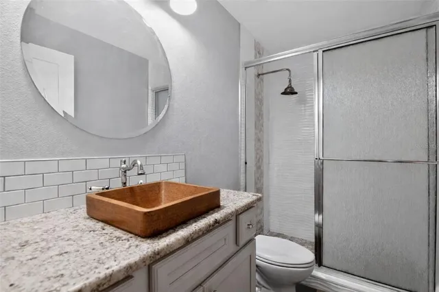 a bathroom with a sink a toilet and a mirror