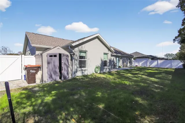 a view of a house with a backyard
