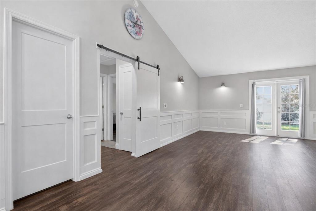 6732 Southwest 109th Lane Ocala, FL 34476 - Photo 10 of 20 an empty room with wooden floor and windows