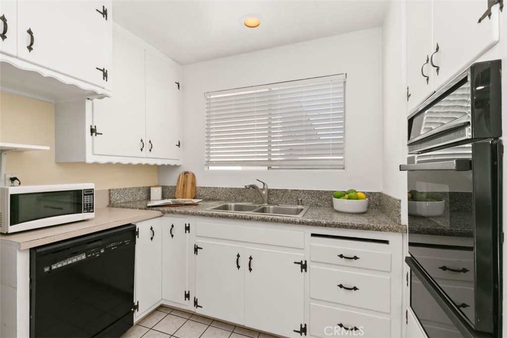 3208 West 152nd Place Gardena, CA 90249 - Photo 18 of 35 a kitchen with granite countertop cabinets stainless steel appliances and a sink