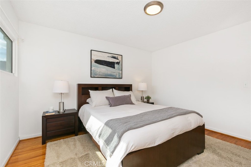 3208 West 152nd Place Gardena, CA 90249 - Photo 22 of 35 a bedroom with a bed and a lamp