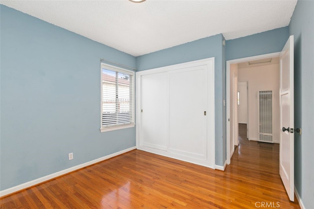 3208 West 152nd Place Gardena, CA 90249 - Photo 25 of 35 a view of an empty room with wooden floor and a window