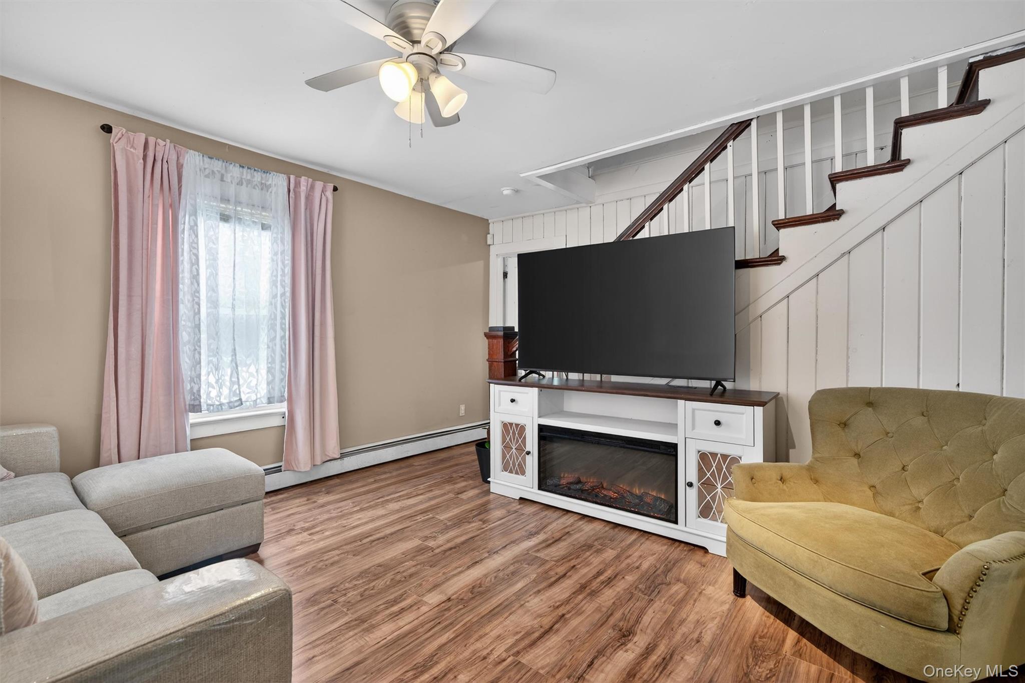 506 Plattekill Ardonia Road Wallkill, NY 12589 - Photo 11 of 44 a living room with furniture a flat screen tv and a fireplace