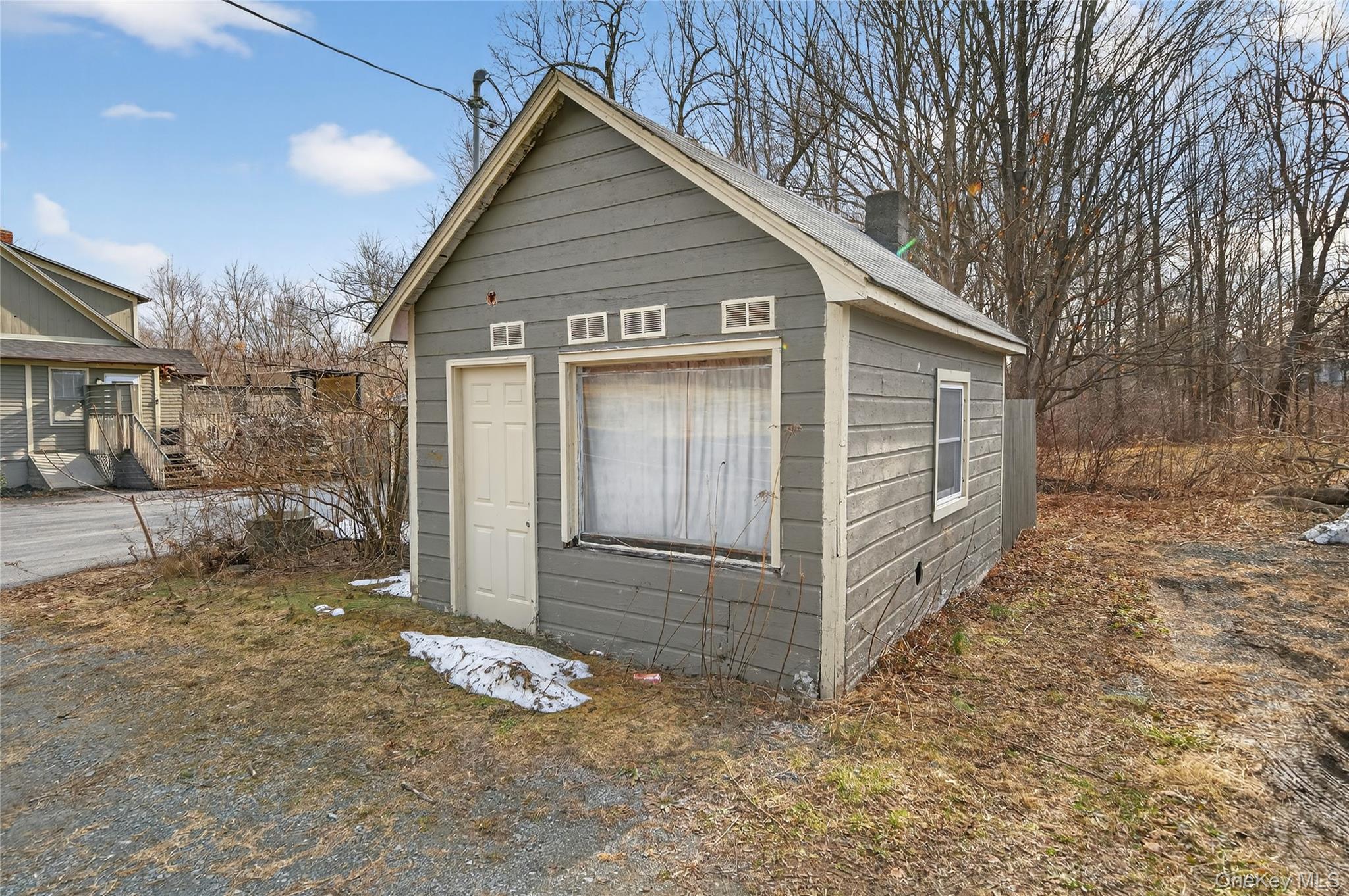 506 Plattekill Ardonia Road Wallkill, NY 12589 - Photo 6 of 44 a view of a wooden house with a large window and wooden fence