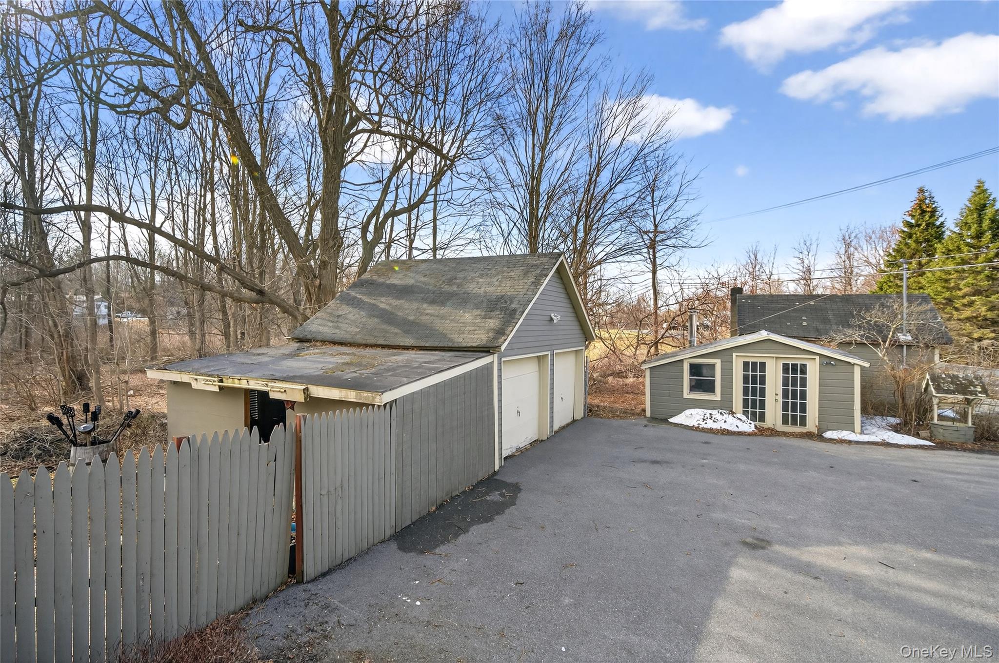 506 Plattekill Ardonia Road Wallkill, NY 12589 - Photo 8 of 44 a view of a house with a wooden fence and large trees