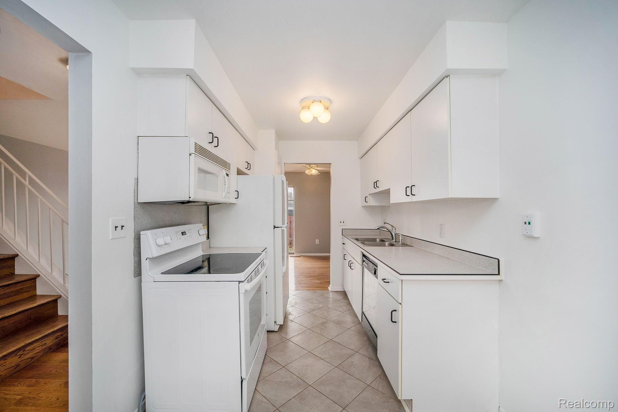 3443 Crooks Road Royal Oak, MI 48073 - Photo 6 of 30 Bright kitchen with a new range, & breakfast nook overlooking the courtyard.