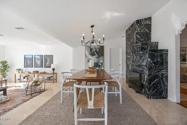 a living room with furniture a chandelier and a rug