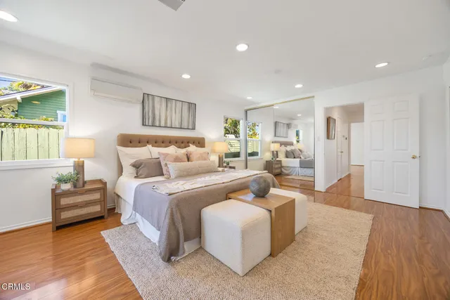 a bedroom with furniture and a wooden floor