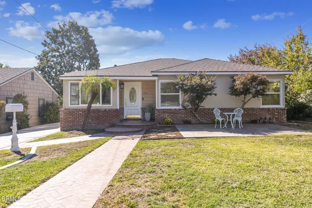 a view of a house with swimming pool and a porch with furniture
