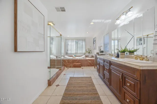 a bathroom with a sink a mirror and a shower