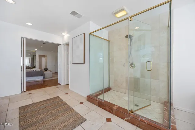 a bathroom with a shower and a sink