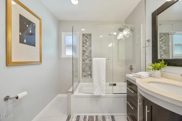 a bathroom with a double vanity sink a mirror and a shower